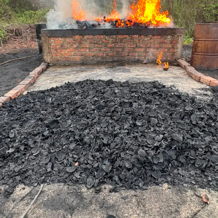 Carbonized charcoal cooling in front of the kiln