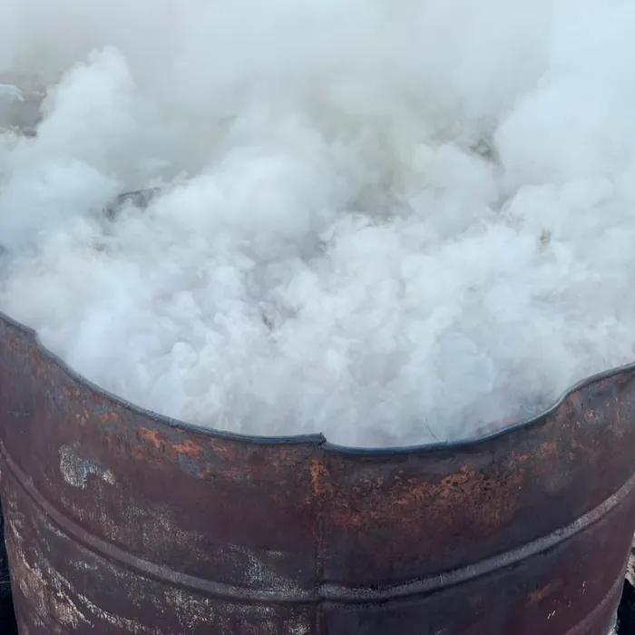 Steam pouring out of a carbonization drum