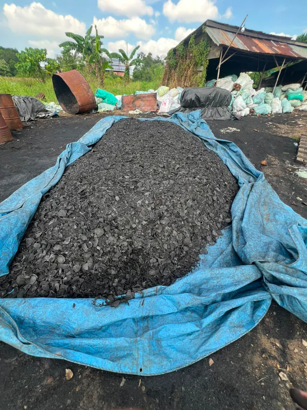 Charcoal drying yard covered with tarpaulin