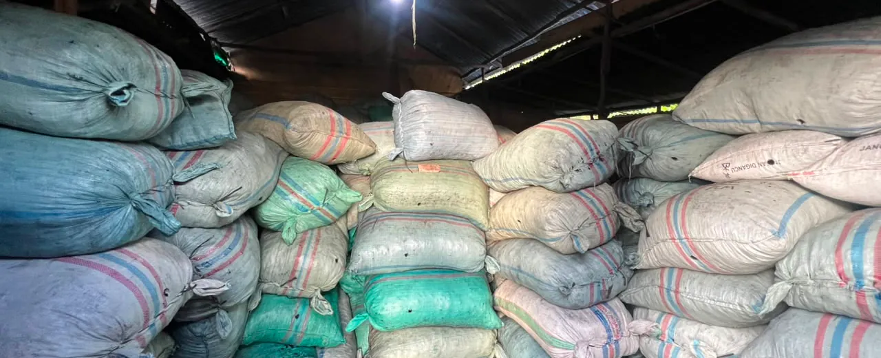 Sacks of coconut shell charcoal stacked inside the warehouse