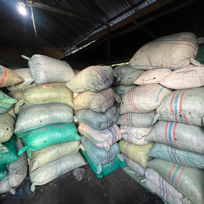 Charcoal sacks stacked to the roof inside the warehouse