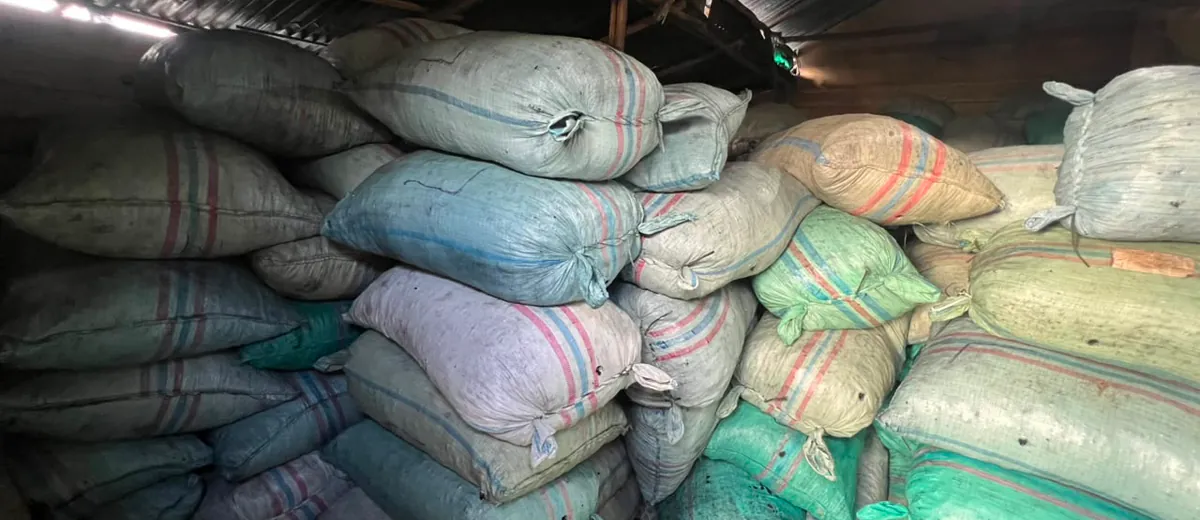 Warehouse aisle filled with stacked charcoal sacks ready to ship